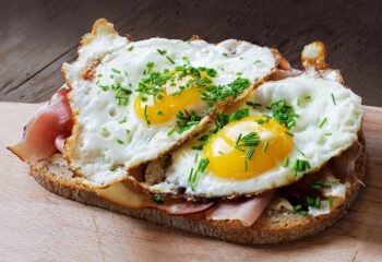 slice of rustic bread with ham or bacon and fried egg, typical  in germany called strammer max