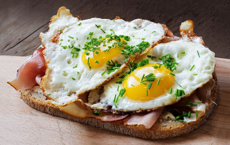 slice of rustic bread with ham or bacon and fried egg, typical  in germany called strammer max